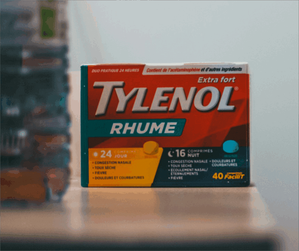 Tylenol Pregnant woman holding Tylenol bottle with warning label highlighting developmental risks
